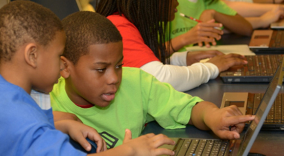 Children using donated laptops for assignments Computers for Kids