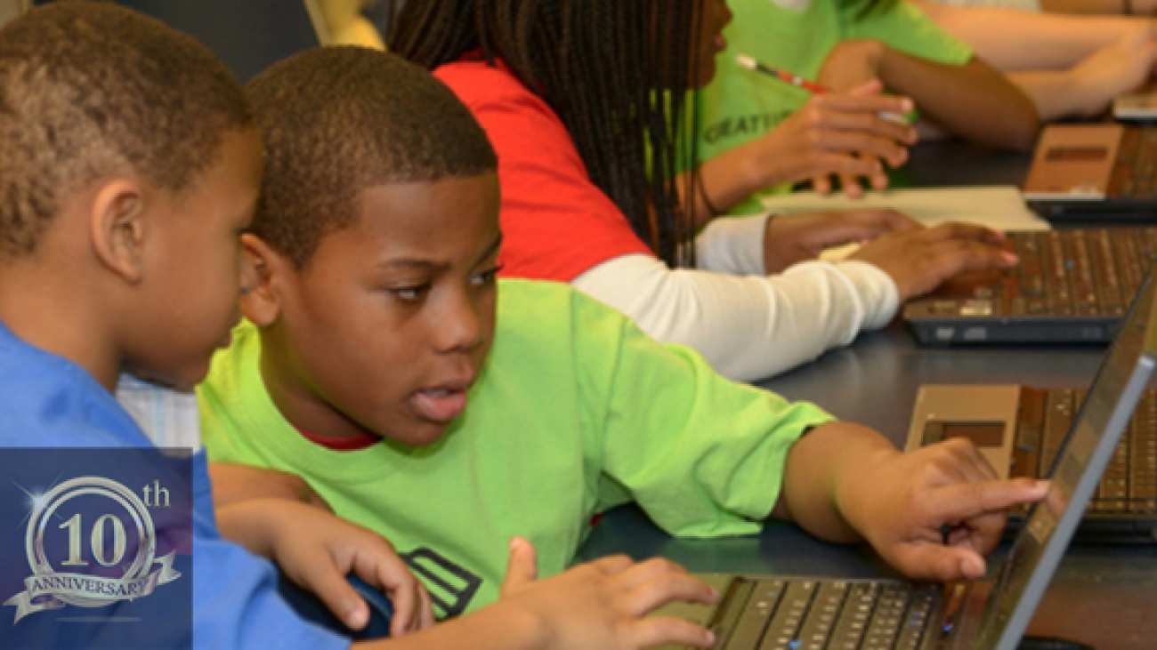 Children using computers end of year donation drive New Life Technology Group