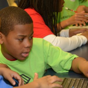 Children using computers end of year donation drive New Life Technology Group