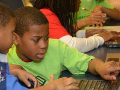 Children using computers end of year donation drive New Life Technology Group